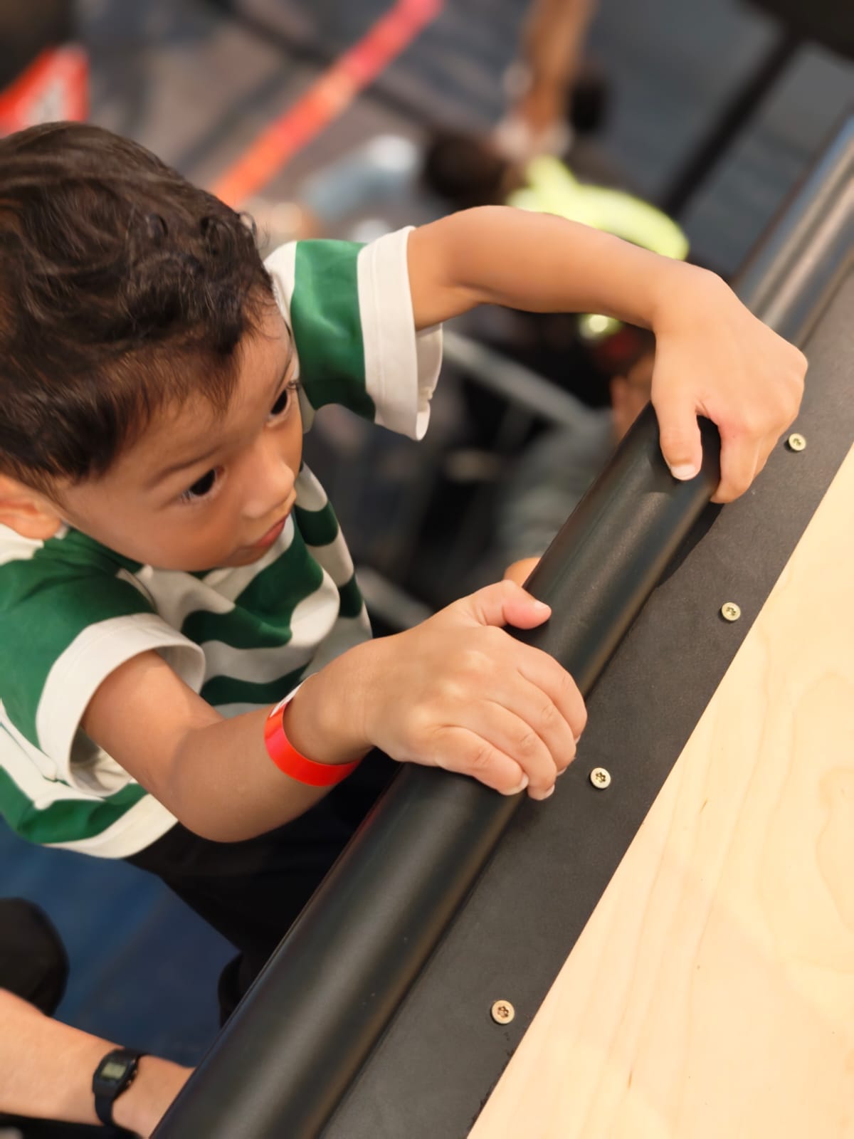 A participant focusing before a climbing obstacle