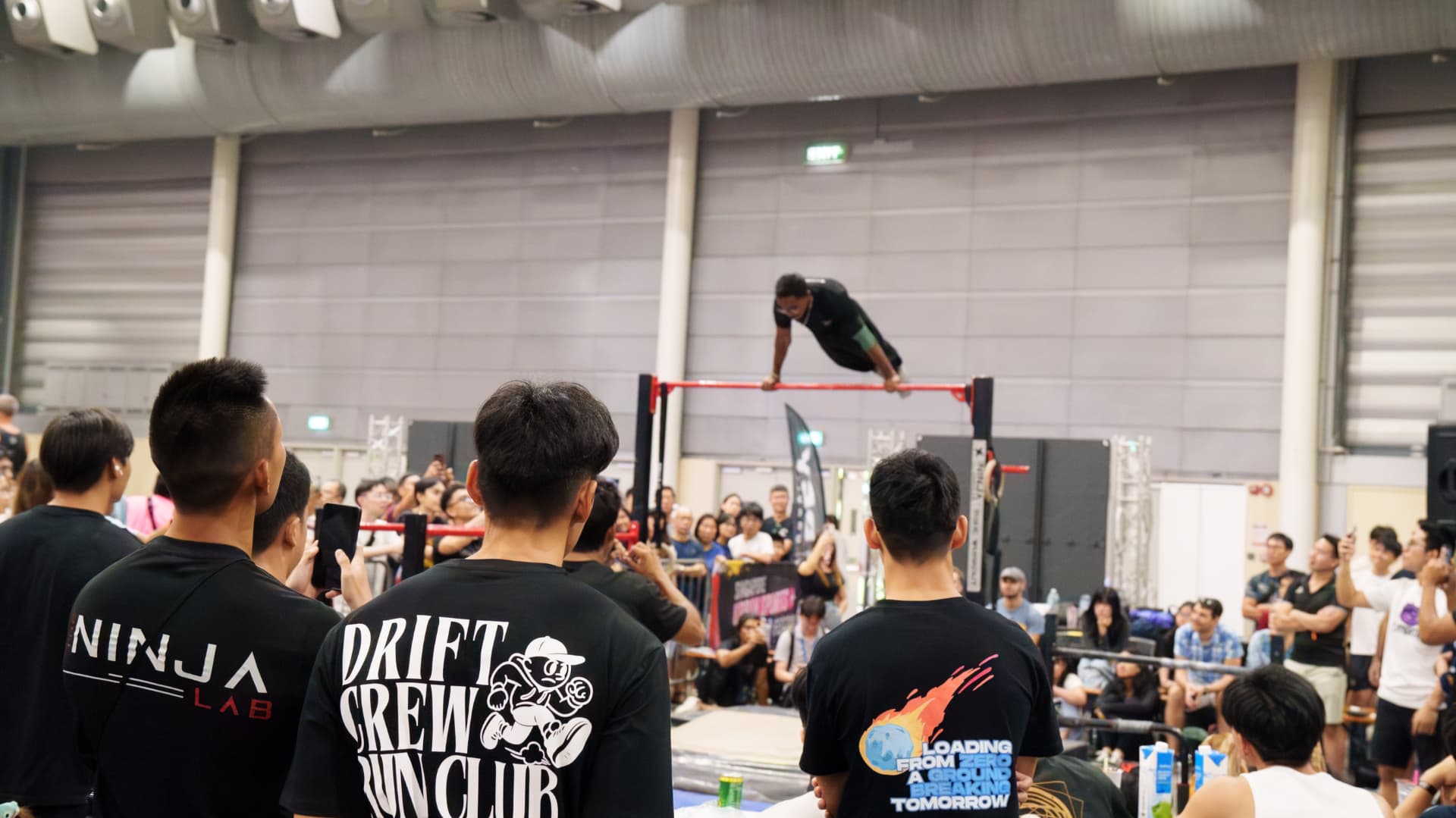 A crowd watching and cheering at a Defy Gravity event.