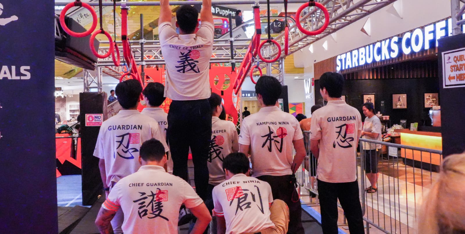 The Ninja Trials crew in guardian shirts gathered under the rig before opening.