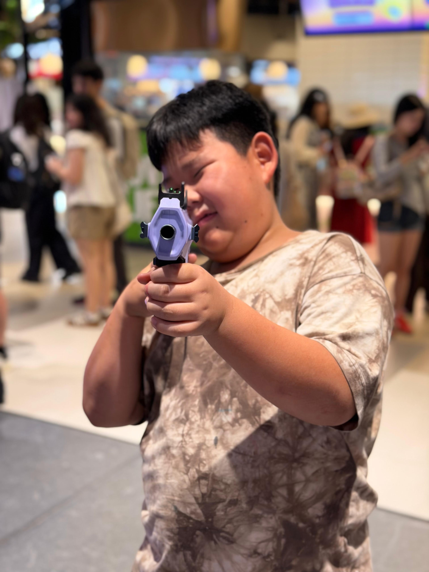 A young participant concentrating on their first shot