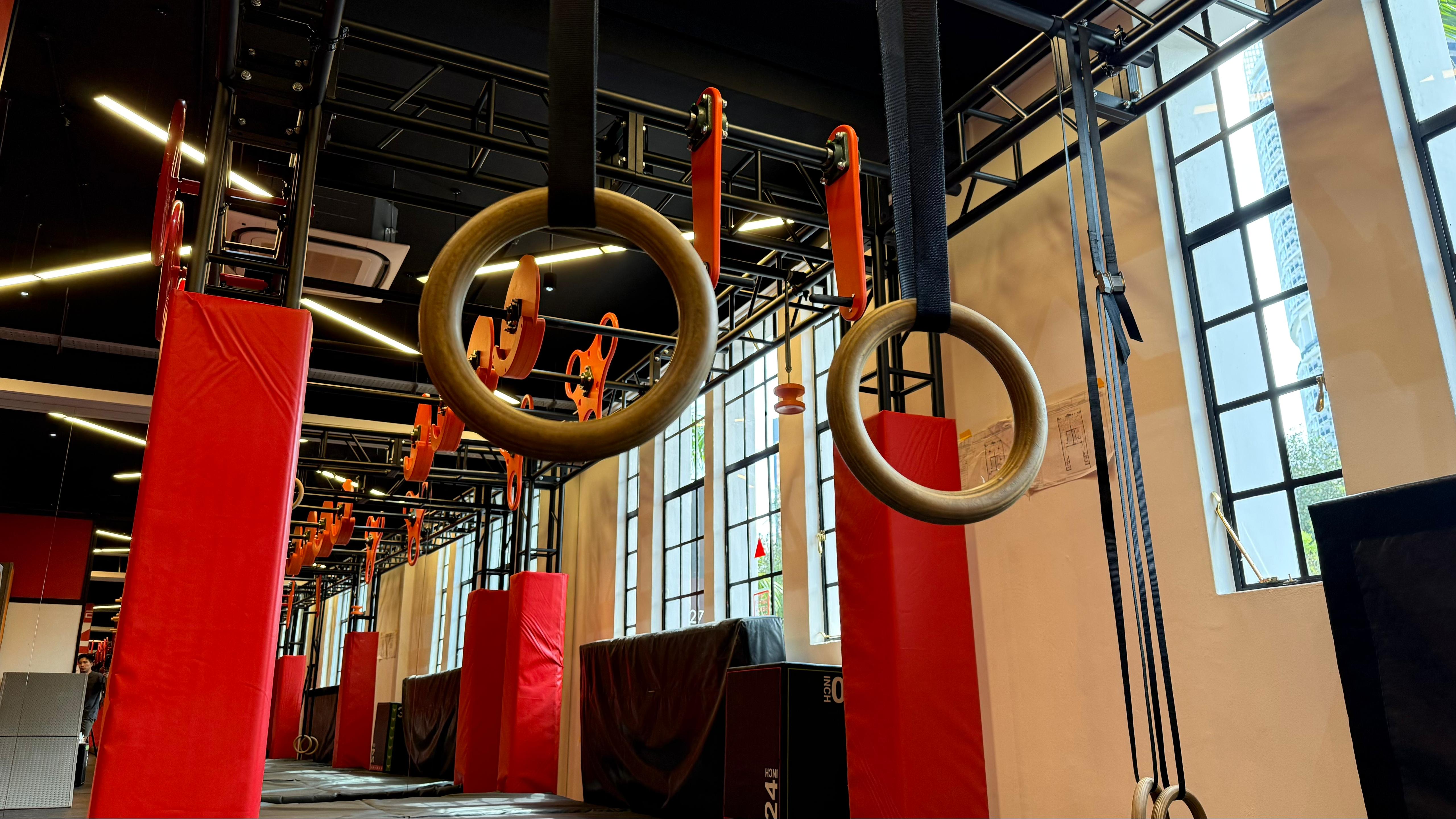 Wooden rings and modular obstacle structures inside The Ninja Lab in Singapore